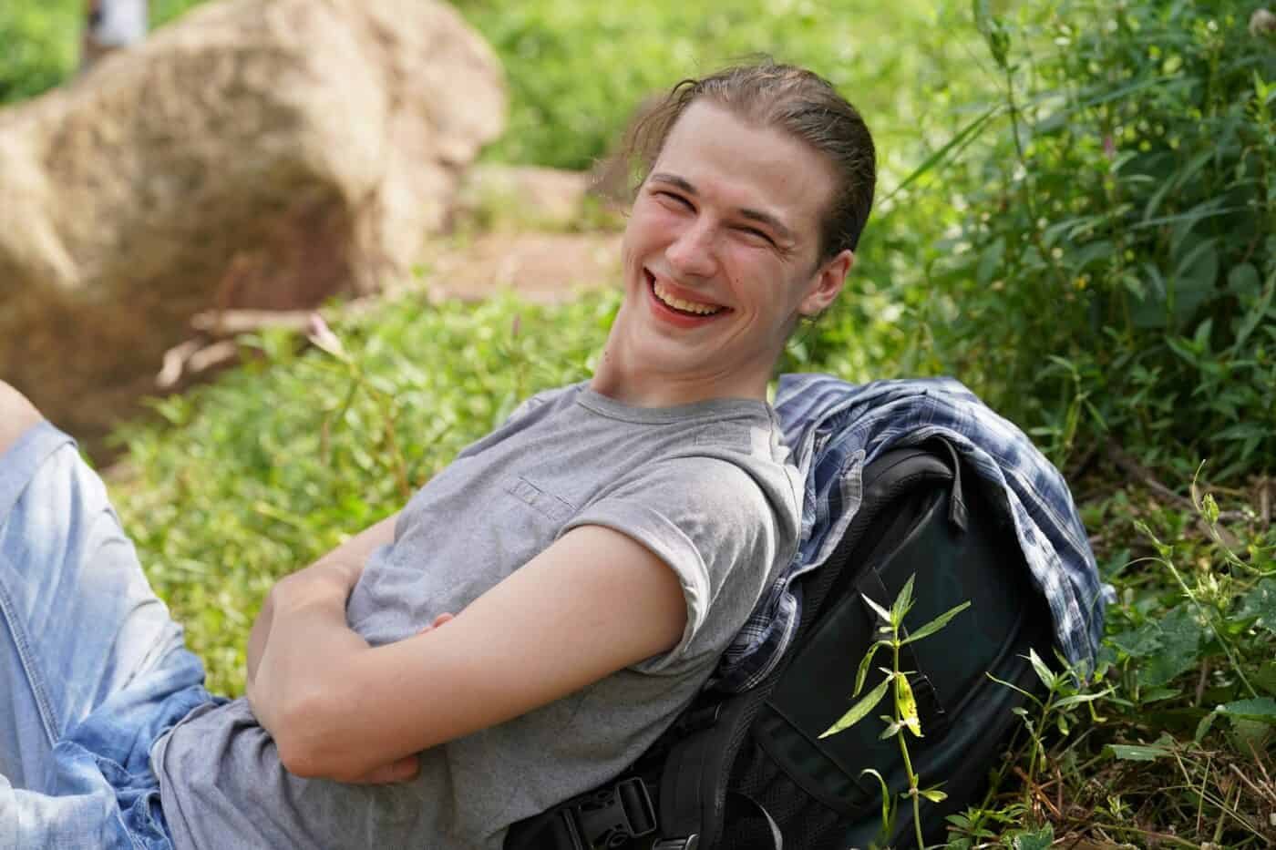 Adventure, travel, tourism, hike and people concept. Group of smiling friends with backpacks outdoor