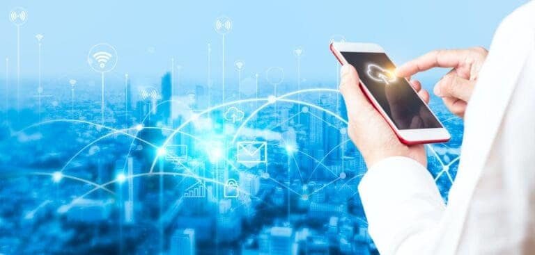 Man's hand using smartphone to connecting data information and blurred city background